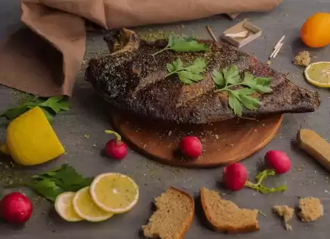 Fish on a cutting board with garnish