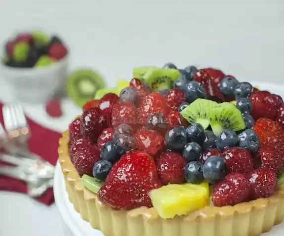 Custard pie with various fruits on top