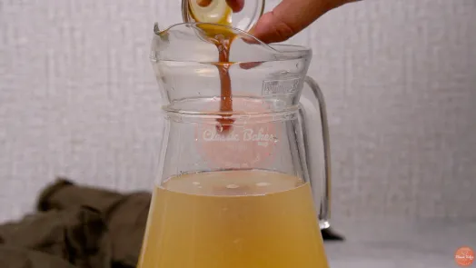 Vanilla essence being poured into the jug of lime juice