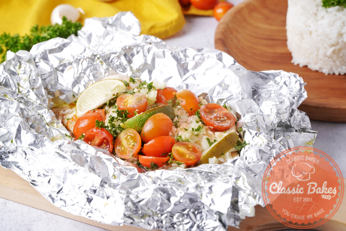 baked tilapia in foil covered with vegetables