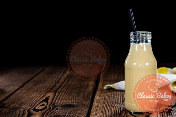 Side shot of Barbadine Punch in a glass in wood background