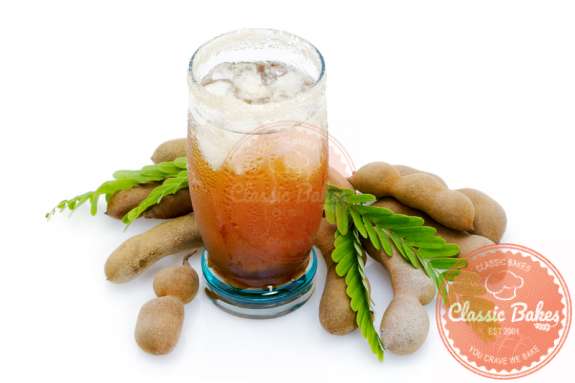Cold Tamarind Juice in a glass with tamarind on side