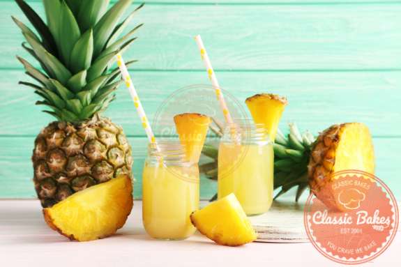 Pineapple Juice in a glass jar with straw and fresh pineapple fruits on the side