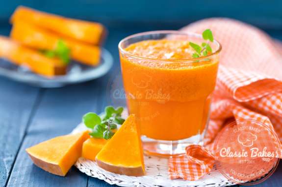 Healthy and Fresh Pumpkin Juice in a glass with fresh pumpkin sliced on the side
