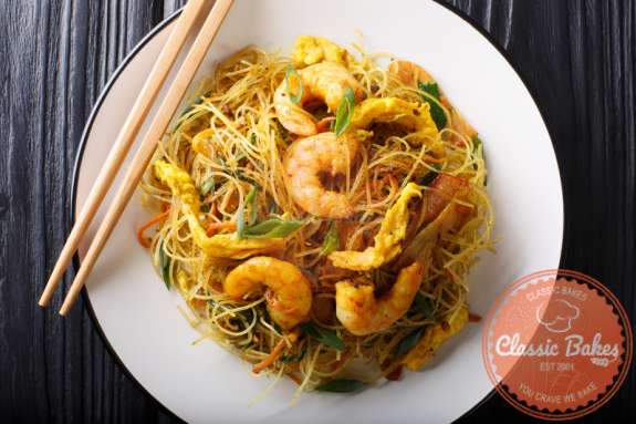 Aerial View Singapore Noodles with Shrimp in a plate
