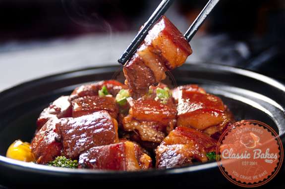 Braised Pork Stew in a pot with chopsticks