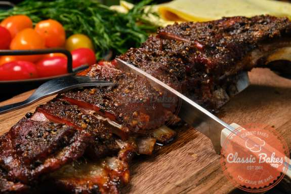 Grilled Lamb with caribbean spices on wooden cutting board. 