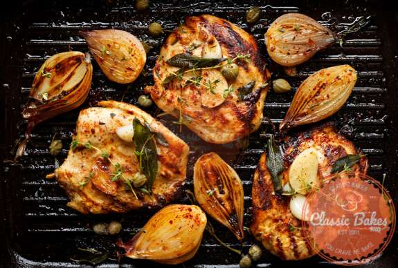 Turkey steak on grill with onions fresh herbs. 