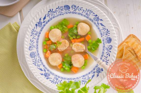 Aerial view of Cornmeal Dumplings in a soup bowl with spoon
