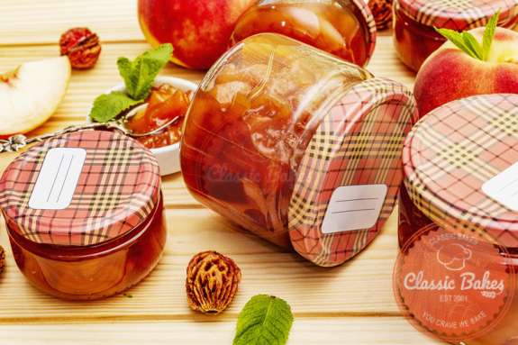 Chunky peach chutney in glass jar in wooden table