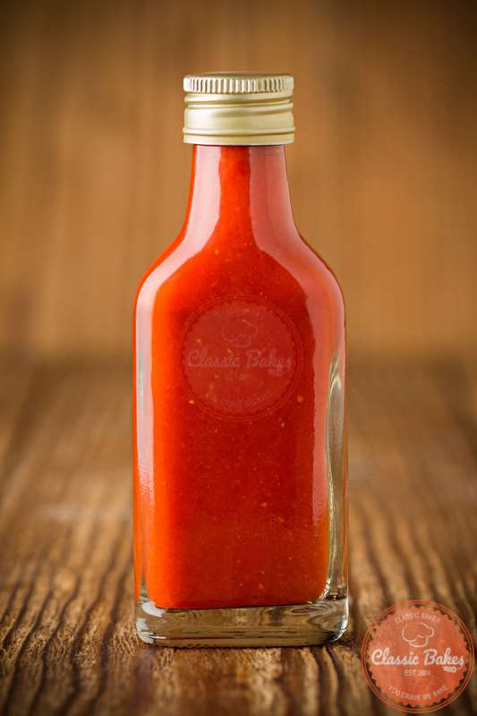 Bottle of Trinidad Hot Sauce in wooden background