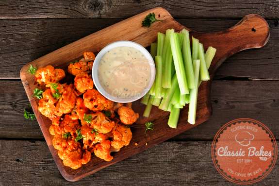 Aerial shot of Cauliflower Bites with a dip and celery on the side