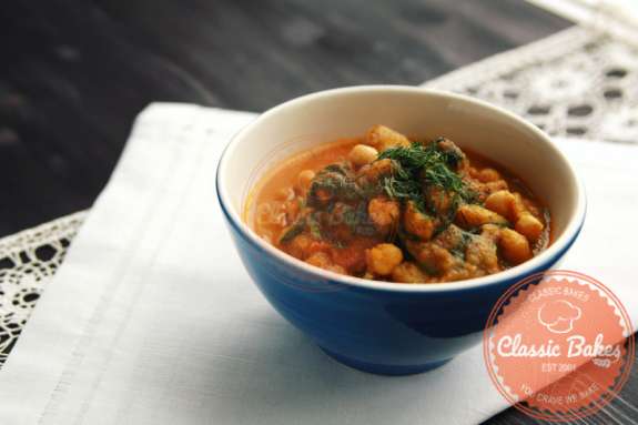 Front shot of Chana Aloo in a bowl on top of a white towel