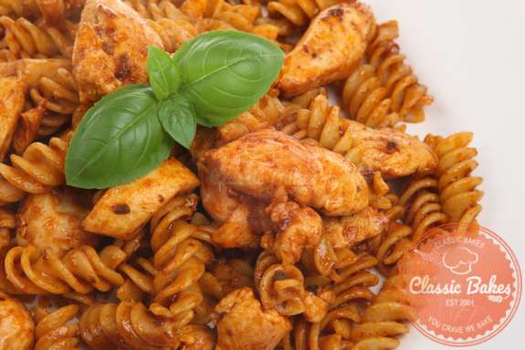 Close up shot of Fusilli Pasta with Chicken with garnish