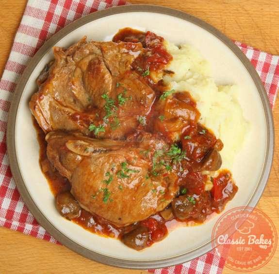 Aerial view of Fall Apart Slow Cooker Pork Chops in a plate with mashed potatoes
