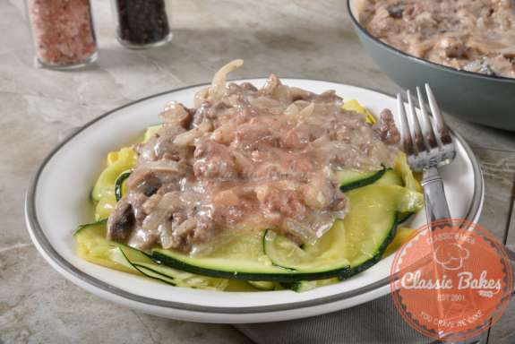 Keto Beef Stroganoff on top of Zucchini pasta in a plate with fork on the side
