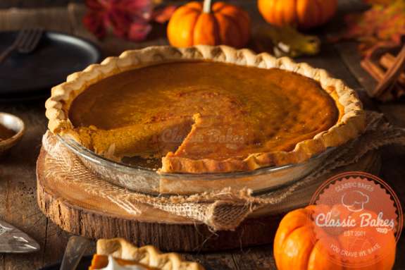 Front shot of Keto Pumpkin Pie in a pie dish with pumpkin on the side