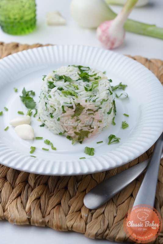 Front shot of Parsley Rice in a plate with utensils on the side