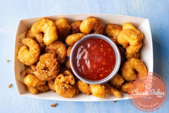 Aerial shot of Popcorn Shrimp in a box with dip