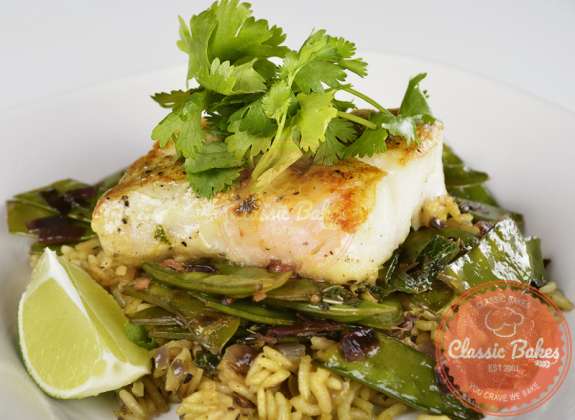 Front shot of Grilled Cod with Wild rice and Sugar Snap Peas with parsley on top