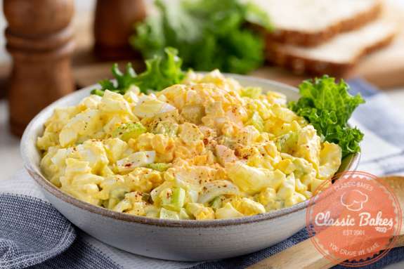 Front shot of Keto Egg Salad in a bowl with lettuce on the side