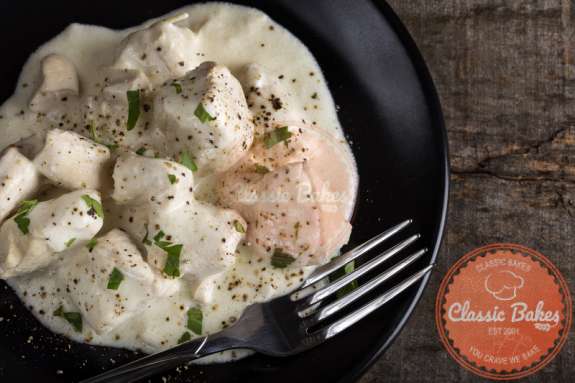 Aerial shot of Low Carb Chicken Alfredo in a plate with a fork on the side