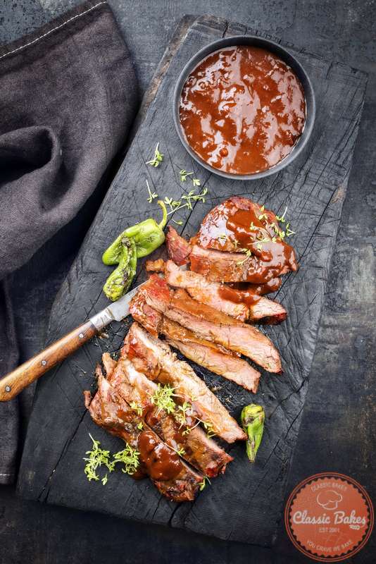 Aerial shot of sliced Air Fryer Flank Steak with sauce and garnish