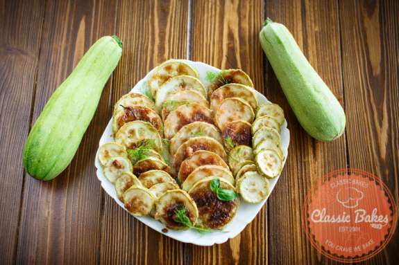 Air Fryer Zucchini with whole zucchini on Sides