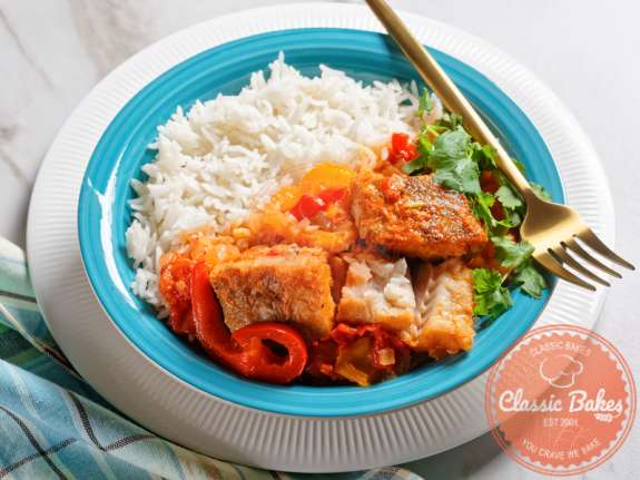 Brown Stew Fish with rice and fork on the side