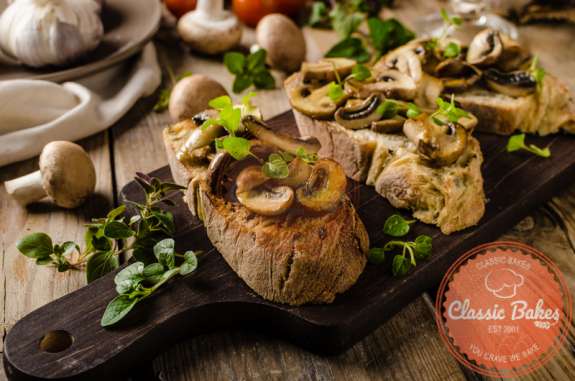 Front shot of Vegan Mushroom Bruschetta in a wooden board