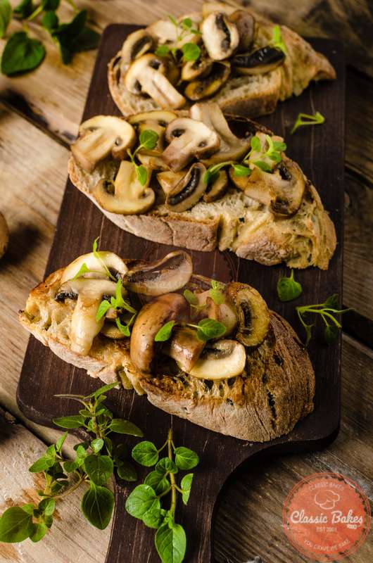 Front close up shot of Vegan Mushroom Bruschetta in a wooden board