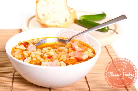 Front shot of Ham and White Bean Soup in a bowl with spoon