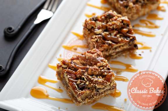 Close up shot of Pecan Pie Bars with caramel drizzles