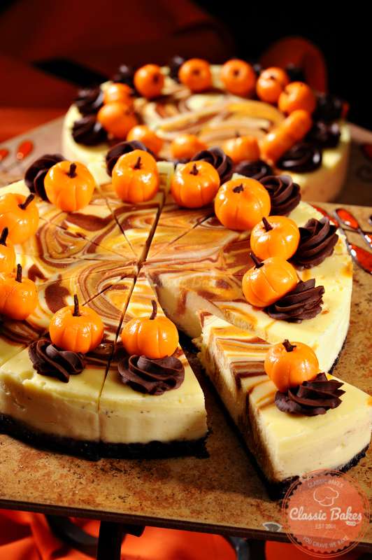 Whole Pumpkin Swirl Cheesecake on top of wooden board