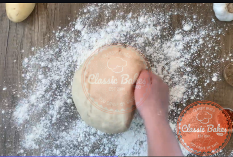 Aerial of a ball of dough on a floured countertop 