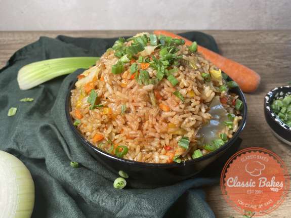 Aerial shot of of a bowl of fried rice with chopped scallions on top 