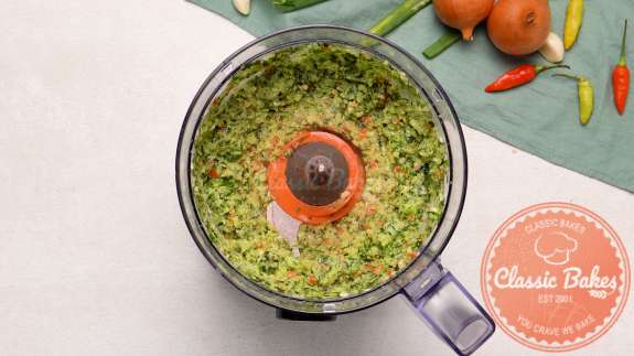 Arial view of a food processor with blended green seasoning 