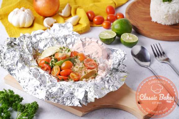 Baked Tilapia in Foil on a cutting board