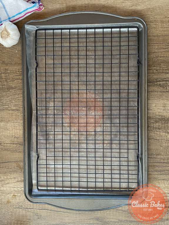 Baking tray with a cooling rack resting on top of it. 