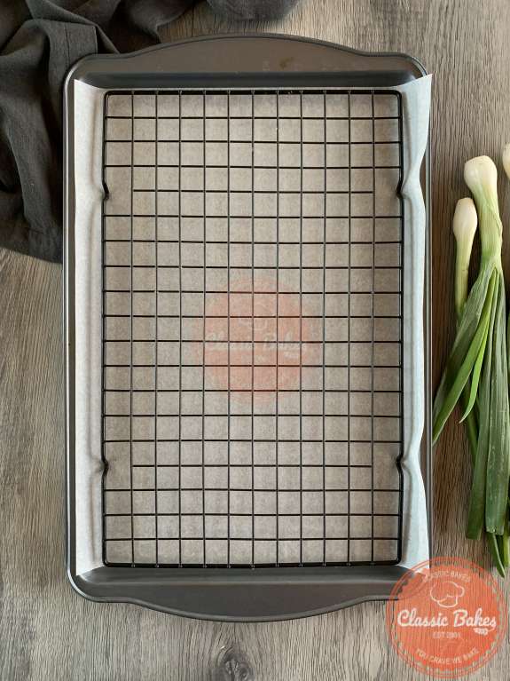 Overview of a cooking rack with a sheet pan underneath 