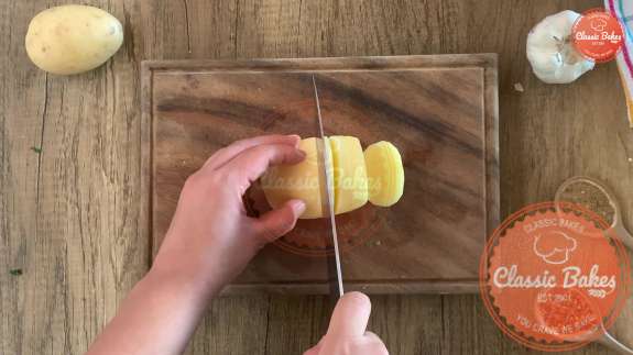 Potatoes being peeled on a cutting board 