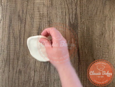 Small circle of dough being placed onto the countertop 