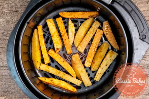 Arial of fries in an air fryer basket 