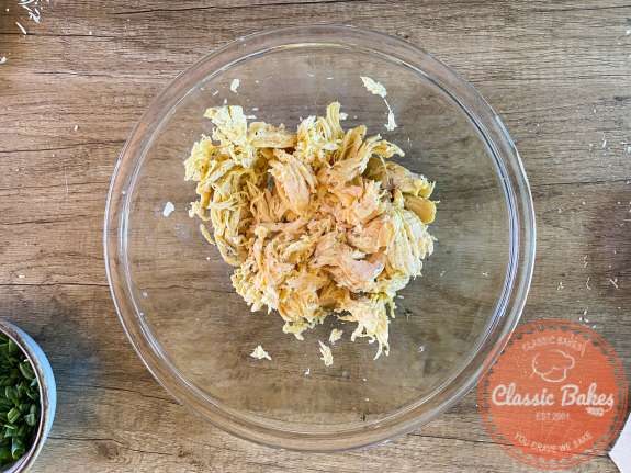 Arial view of shredded chicken in a glass bowl 