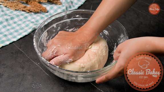 Dough being kneaded in a bowl 