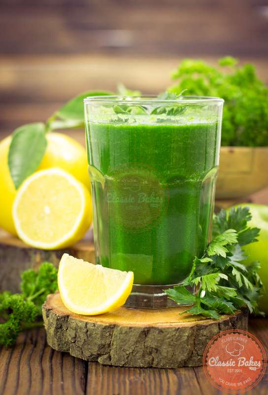 Sideview of a glass of green goddess smoothie