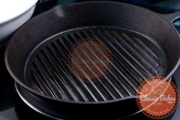 Grill pan heating up on a stovetop 