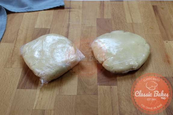 Overview of 2 wrapped pieces of dough on a countertop