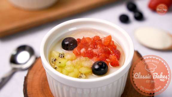 Overview of cream of wheat portioned in a bowl topped with fruit 