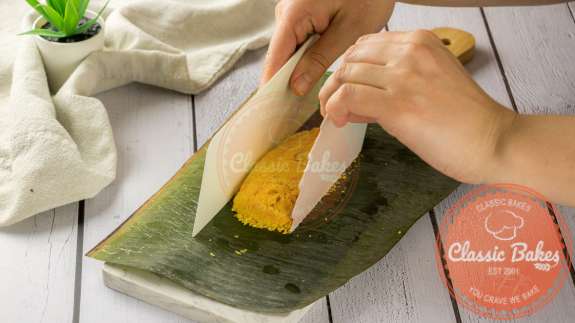 Paime filling being added to a banana leaf. 